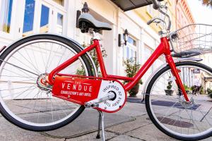 a red bicycle parked in front of a red brick building at The Vendue in Charleston