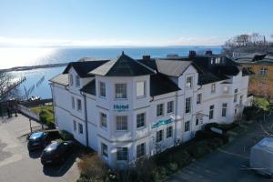 a large white building with a black roof at Hotel Waterkant in Sassnitz