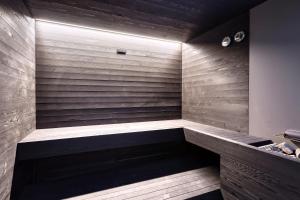 a sauna with wood paneling and a wooden wall at Elia Mykonos Resort in Elia Beach