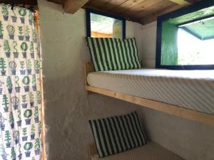 a bedroom in a tiny house with a window at Vistalago Garden in Monteleone Rocca Doria