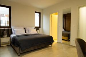 a bedroom with a bed and a mirror at Villa Forte Mare in Petrovac na Moru