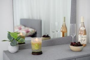 a counter top with two glasses and a mirror at PRINCESS of the Dead Sea by CROWN in Neve Zohar