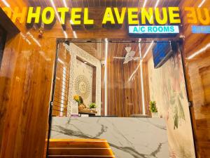 a hotel entrance with a sign that reads hotel avenue sig rooms at HOTEL AVENUE AC ROOMS in Ahmedabad
