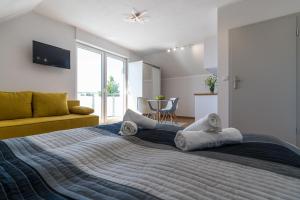 a bedroom with a large bed with towels on it at Verde House in Karwia