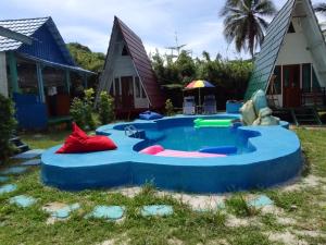 a pool in the yard of a house at Tanjong Tinggi Cottage in Sijuk