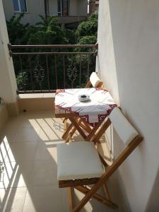 a table and chairs sitting on a balcony at Hrisi in Chernomorets
