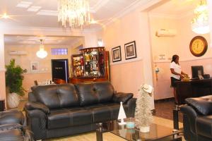 a woman standing at a desk in a living room at J Gibson Hotel in Lagos