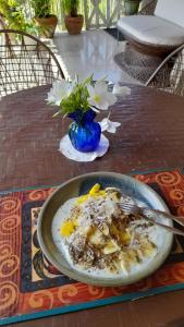 a bowl of food on a table with a plate of food at Neita's Nest in Kingston