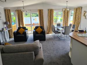 a living room with a couch and chairs and a table at Mildreds Lodge with Hot Tub in Felton