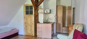 a room with a kitchen with a sink and a refrigerator at Marka Pokoje Gościnne in Mielno