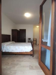 a bedroom with a bed and a mirror in it at Tiny House Dolomiti in Sovramonte