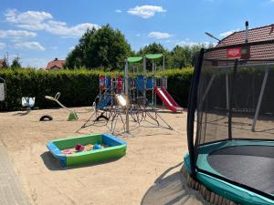 a playground with a play set and a trampoline at SIEDEM WYDM in Rowy