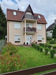 a house with a lawn in front of it at Barka Apartman in Nagykanizsa