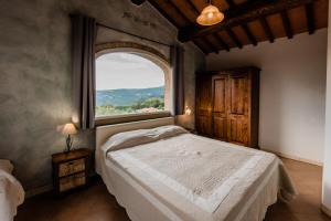 Postel nebo postele na pokoji v ubytování Residence Borgo Felciaione
