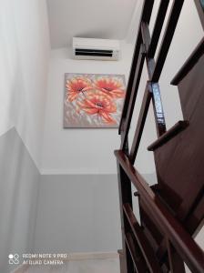 a painting of flowers on a wall next to a staircase at Apartma Izola in Izola