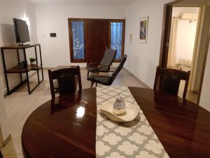 a living room with a dining room table and chairs at Departamentos Uma in San Rafael