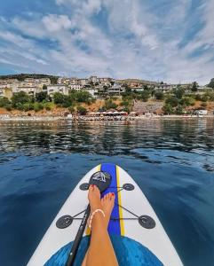 a woman is paddling a paddle board on the water at Jasmina in Senj