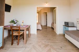 a small apartment with a table and a bedroom at Borgo Felciaione in Riparbella
