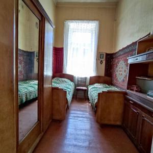 a small room with two beds and a mirror at Renting a full apartment in the centre of Gyumri in Gyumri