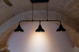 a trio of lights hanging from a ceiling at CASA BEATA ELIA in Bari