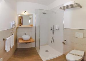 a bathroom with a shower, toilet and sink at Hotel I Graniti in Villasimius
