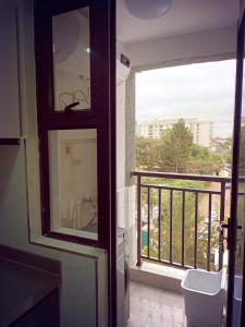 a bathroom with a balcony with a toilet and a window at Kileleshwa Lavington Shii apartment in Nairobi