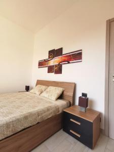 1 dormitorio con cama y mesa pequeña en Uro's Home, en Lonate Pozzolo