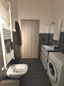 ein Badezimmer mit einem Waschbecken und einer Waschmaschine in der Unterkunft Uro's Home in Lonate Pozzolo
