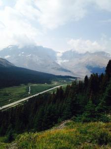 a road in the middle of a valley with mountains at 316 Patricia Street Accommodation in Jasper