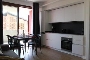 a kitchen and dining room with a table and chairs at Borgo Apartments Borgo 56 in Borgomanero