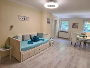 a large room with a bed and a dining room at Das Weisse Haus Bockholt in Soltendieck +11 photos
