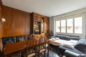 a living room with a table and a couch at Montebello, Bologna by Short Holidays in Bologna