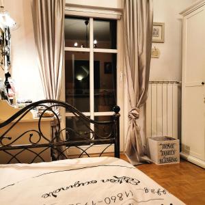a bedroom with a bed in front of a window at Apartmaji ARKO in Ribnica