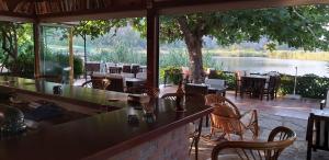 a restaurant with tables and chairs and a view of a lake at Lindos Pension in Dalyan