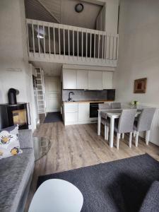 a kitchen and living room with a couch and a table at Siulanlumo in Saariselka