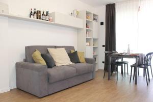 a living room with a gray couch and a table at Borgo Apartments Borgo 56 in Borgomanero