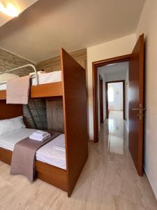 a room with two bunk beds and a hallway at Verano house in Néa Tríglia