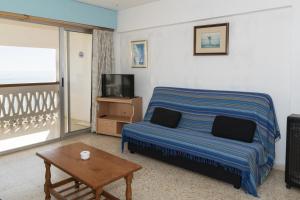 a bedroom with a bed and a table and a tv at Lider, 10-B in Cullera