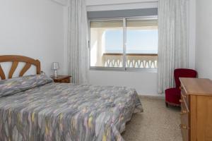 a bedroom with a bed and a window and a desk at Lider, 10-B in Cullera +24 photos