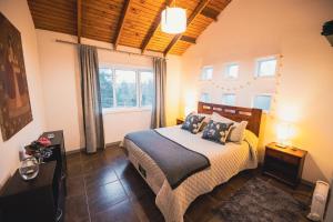 a bedroom with a bed and a large window at Bungalow Miramar & Jeronimo at Casa Marin Vineyards in Cartagena