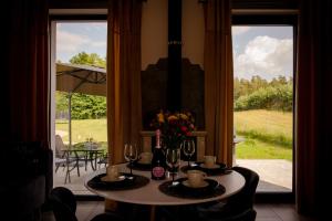 a table with flowers and wine glasses in a room at Osada Za Dębami, Podlasie, Sejny in Sejny