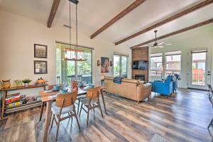 a living room with a table and chairs and a couch at Mountain High Pines Retreat with Hot Tub and Views! in Pine