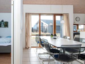 Thorsminde的住宿－8 person holiday home in Ulfborg，厨房以及带桌椅的用餐室。