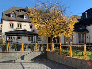 a house with a fence in front of it at Weinhof Michael Morbach in Zeltingen-Rachtig +26 photos