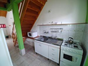 a kitchen with a stove and a sink at Ankara 3 in Las Grutas
