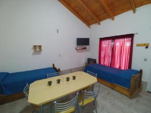 a room with a table and a bed and a desk at Ankara 3 in Las Grutas