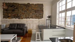 a kitchen and living room with a couch and a table at APARTAMENTOS RAMAR 1 in Pravia +18 photos