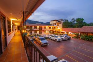 a balcony of a hotel with cars parked in a parking lot at Hotel Vanguardia Natural in Villavicencio
