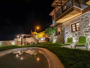 a house with a swimming pool at night at Casa da Mãe - Izei in Chaves