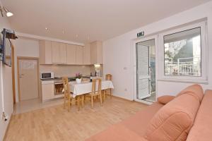 een grote woonkamer met een tafel en een keuken bij Apartment Mate in Omiš